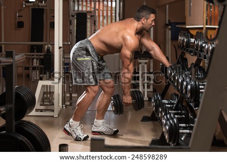 Mexican Bodybuilder Doing Heavy Weight Exercise For Back With Dumbbells