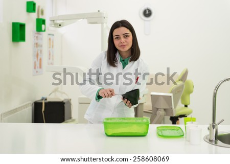 Young Dentist Doctor Is Working On The Mould To Make A Model of A Mouth