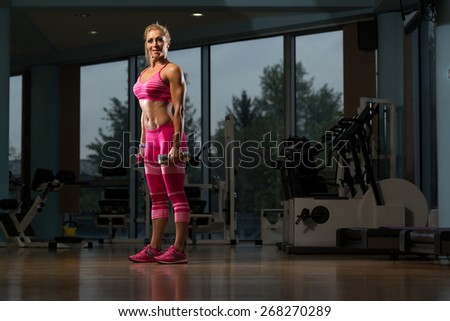 Middle Age Woman Performing Dumbbell Squats - One Of The Best Body Building Exercise For Legs