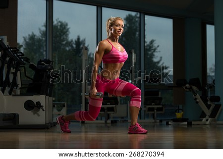 Middle Age Woman Performing Dumbbell Squats - One Of The Best Body Building Exercise For Legs