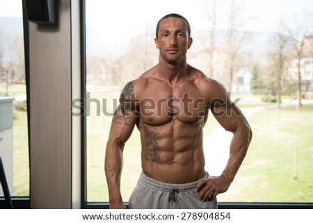 Portrait Of A Physically Fit Man In Modern Fitness Center