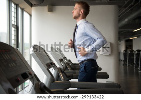 Businessman Running On Treadmill At A Health Club