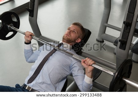Business Man In Gym Exercising Chest On The Bench Press