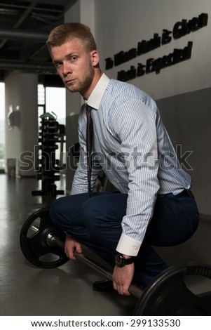 Young Business Man Doing Heavy Weight Exercise For Back In Gym