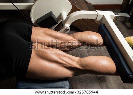 Bodybuilder Doing Heavy Weight Exercise For Legs Hamstrings