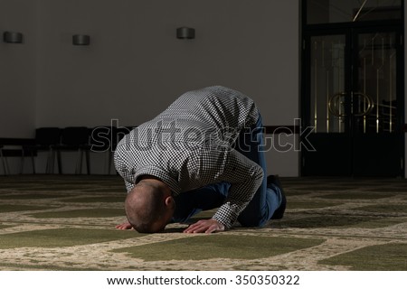 Young Muslim Man Making Traditional Prayer To God Allah