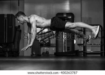 Young Man Athlete Doing Extreme Pushups As Part Of Bodybuilding Training