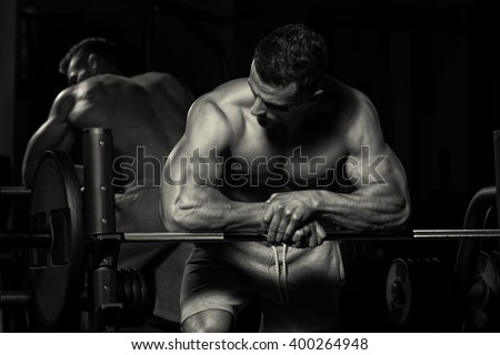 Healthy Young Man Resting In Healthy Club Gym After Exercising