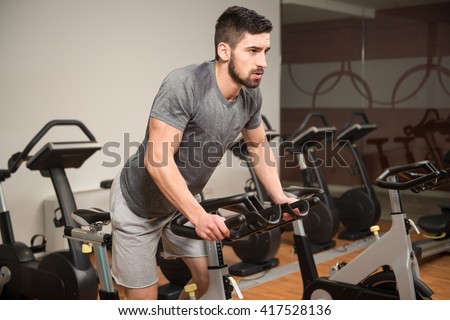 Man In The Gym - Exercising His Legs Doing Cardio Training On Bicycle