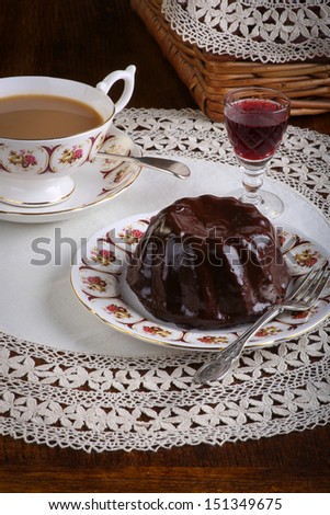 Mini Pound Cake - Chocolate hazelnut cake on old pictures tea cup, side plate on lace and red wine liquor