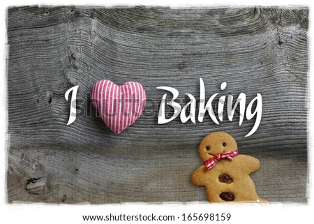 I love baking message Christmas handmade decoration red stripes fabric hearth over rustic Elm wood background - retro style design, Gingerbread cookie