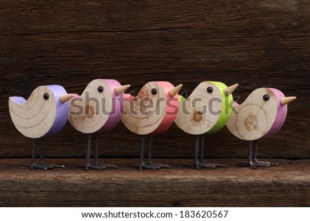 Five wooden toy birds figure symbol on old rough background with copy space