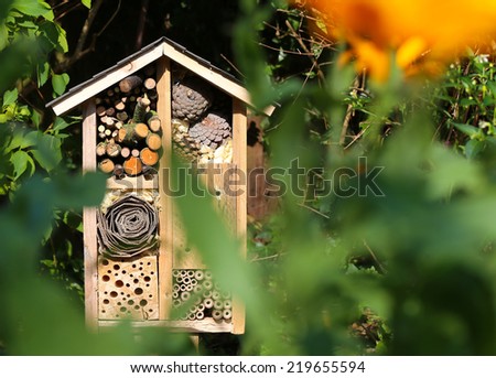 Wooden insect house decorative bug hotel, ladybird and bee home for butterfly hibernation and ecological gardening