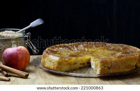 Caramelised apple tarte tart tartin fancy cake pie on glass plate slice cut off on saple table
