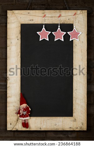 Merry Christmas and Happy New Years chalkboard blackboard stars and puppet decoration restaurant vintage menu design on painted reclaimed wooden frame, dark brown brick wall, copy space