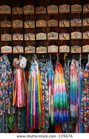 Boards with wishes on them, hung at a shrine. Origami cranes, made to pray for good health.