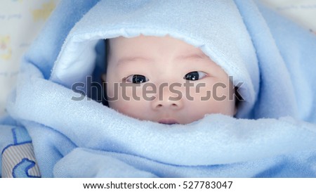 baby boy is hiding under the blue blanket,asian baby,baby in home,boy,Portrait of a crawling baby on the bed in her room