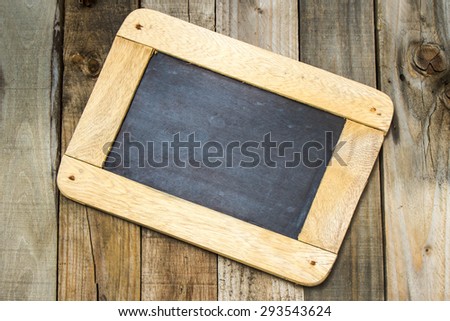 blank writing black slate on wooden background