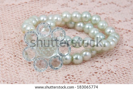 Imitation pearl hair band closeup on sweet lace.