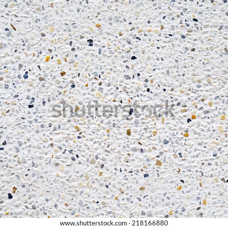 White cement wall with tiny rock on surface texture, grunge background.
