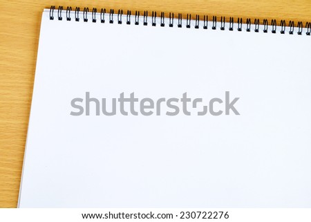 Blank white notebook on wooden board, background, template