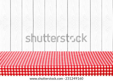 Empty table covered with red checked tablecloth background, for product display montage
