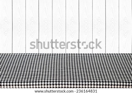 Empty table covered with black and white checked tablecloth background, for product display montage