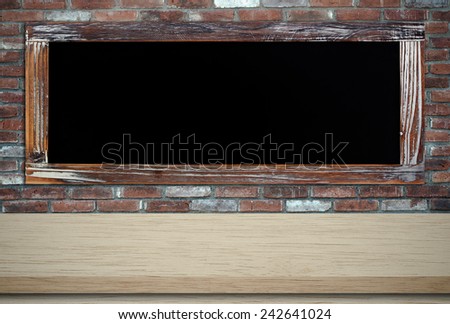 Empty vintage chalk board on table with brick wall background,template ,display