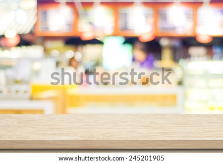 Empty wood table and blurred cafe with bokeh light background. product display template