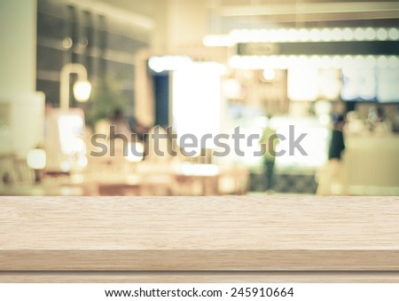 Empty wood table and blurred cafe with bokeh light background. product display template