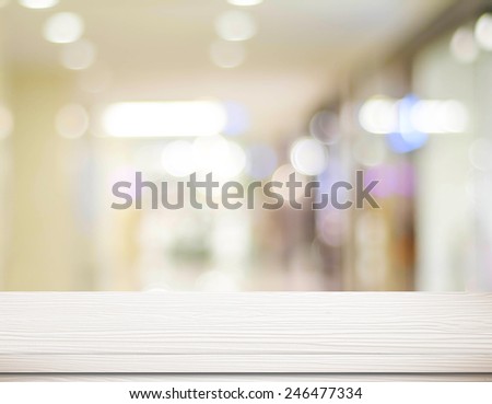 Empty white table and blurred store with bokeh background, product display template.