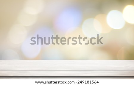 Empty white wooden table over blur festive bokeh background, for product montage