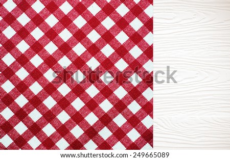 White wood table covered with red checked tablecloth, top view, background, product display template