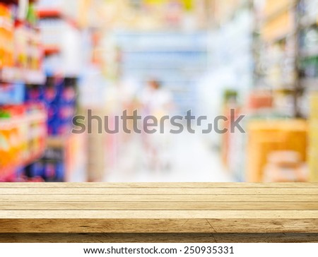 Empty table over blur supermarket with bokeh background,  product display template.