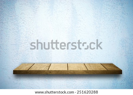 Wood shelf on blue cement wall background