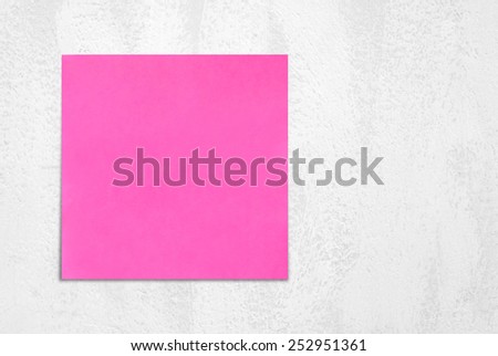 Blank sticky note paper on white cement wall background