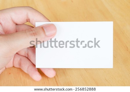 Name card in hand, business background.