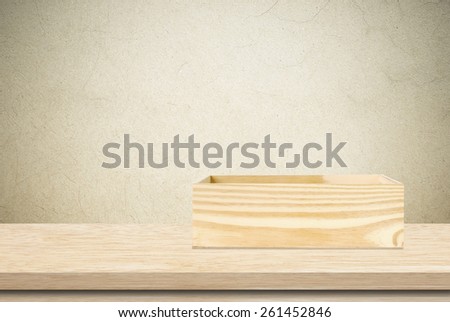 Wood storage box on table over cement wall background, product display montage