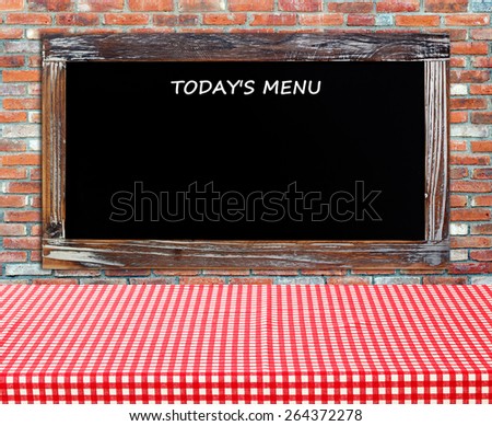 Today\'s menu on vintage chalk board over table with red check tablecloth background