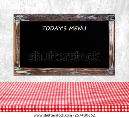 Today\'s menu on vintage chalk board over cement wall background