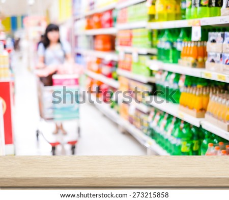 Empty table over blur supermarket with poeple background, product display, template, business concept