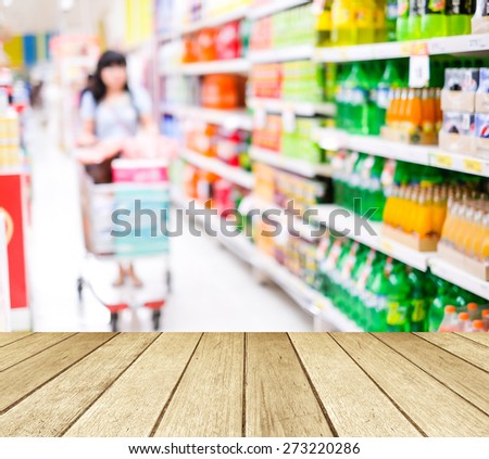 Perspective wood over blur supermarket with people background, product display, template, business concept