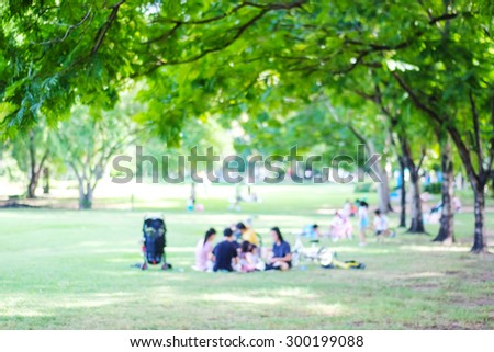 Blurred background of people activities in park with bokeh light, spring and summer