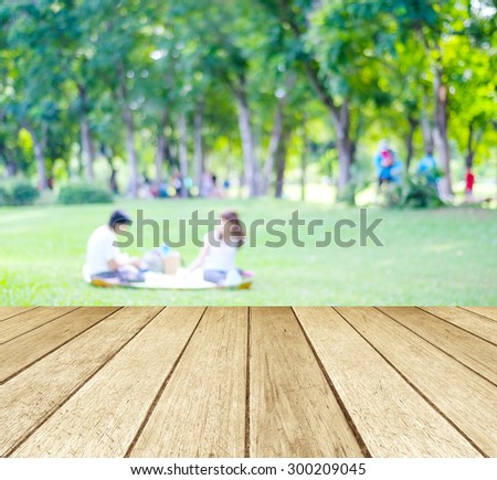 Perspective wood with blurred people activities in park background, spring and summer
