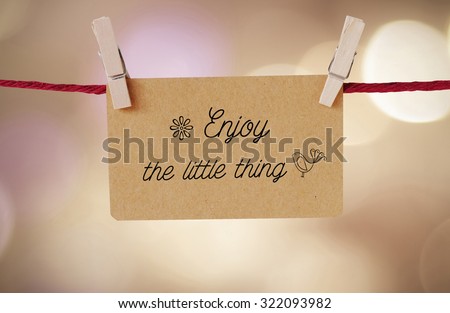 Enjoy the little thing : Quotation on paper card hanging on red clothesline background
