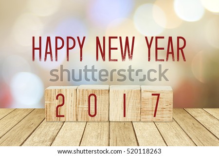 Wooden cubes with 2017 and happy new year over blur bokeh background, new year banner