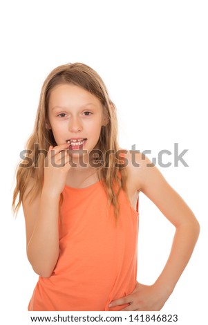 Young girl with long hairs lost a tooth. Isolated on white background.