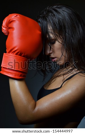 beautiful woman with the red boxing gloves, black background