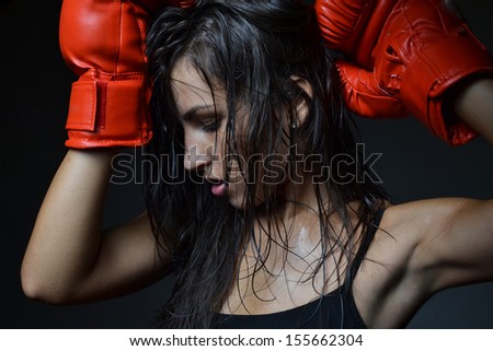 beautiful woman with the red boxing gloves, black background