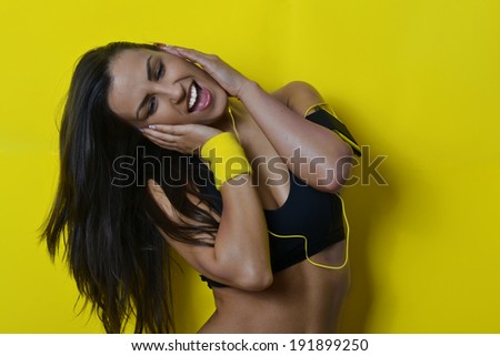 beautiful fitness woman, against the yellow background